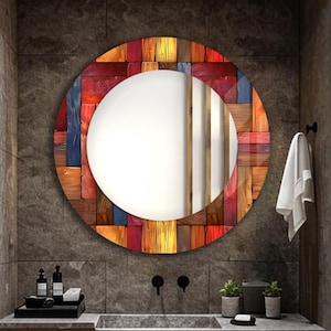 May include: A round mirror with a colourful wooden frame. The frame is made of different coloured wood planks, creating a patchwork design. The mirror is hanging on a wall in a bathroom.