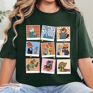 Pode incluir: Camiseta verde floresta com uma grade de retratos de personagens de desenhos animados em estilo polaroid. Os retratos incluem um gato, uma cobra, um castor, uma raposa, um coelho e uma pregui&ccedil;a. O texto "FOREST GREEN" &eacute; impresso na parte inferior.