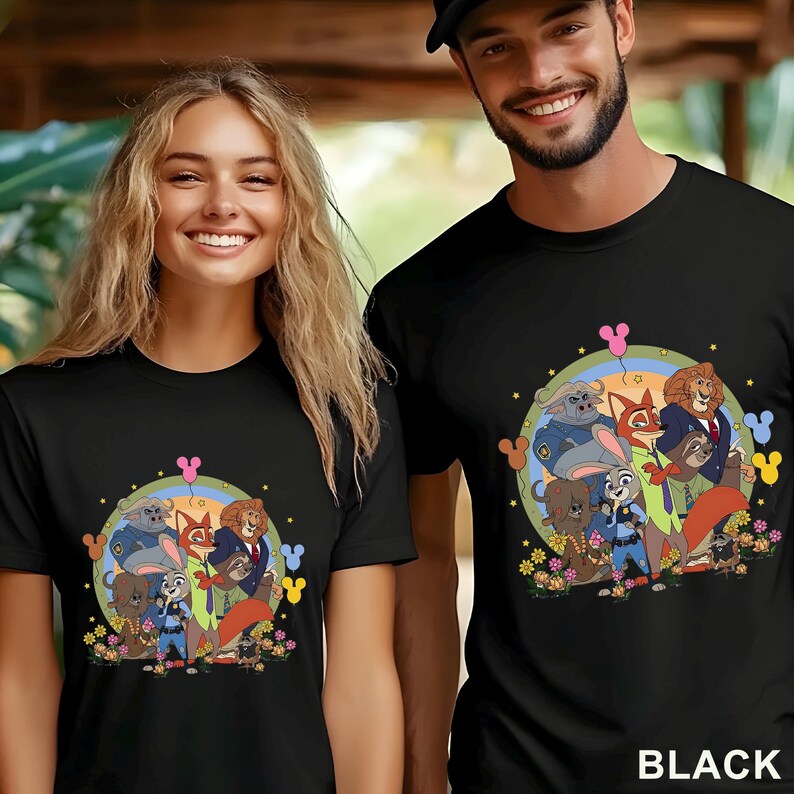 May include: Black t-shirts with a cartoon graphic of animal characters. The graphic includes a fox, lion, bunny, and other animals in a circular design with flowers and Mickey Mouse-shaped balloons. The word "BLACK" is printed at the bottom.