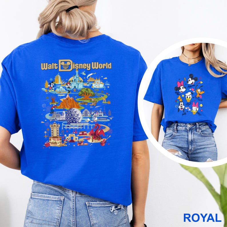 Op de afbeelding: Koningsblauw T-shirt met een kleurrijke afbeelding van Disney World attracties en personages. De achterkant van het shirt toont de woorden "Walt Disney World" in gouden letters boven een gedetailleerde illustratie van het park. Een tweede shirt met Disney-personages is ook zichtbaar.
