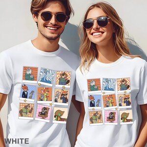 Pode incluir: T-shirts brancas com uma colagem de desenhos animados de personagens de animais em v&aacute;rias poses. As camisas t&ecirc;m gola redonda e mangas curtas. A palavra "WHITE" &eacute; impressa na parte inferior da camisa.