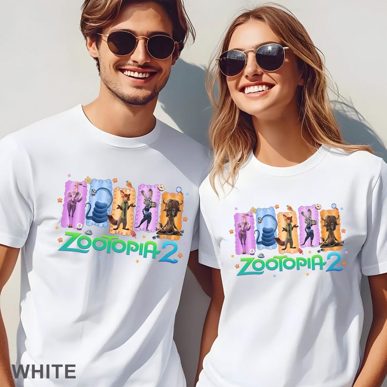 May include: White t-shirts featuring a colorful graphic of characters from Zootopia 2. The design includes Judy Hopps, Nick Wilde, and other characters. The text "Zootopia 2" is in green and blue. The word "WHITE" is at the bottom.