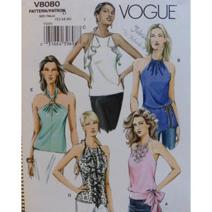 May include: A sewing pattern for five different halter tops. The pattern is for sizes 12-14-16. The tops are shown in various colours and fabrics, including a white top with ruffles, a blue top with a tie, a green top with a knot, a leopard print top with ruffles, and a pink top with a bow.