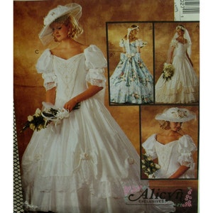 May include: A vintage wedding dress pattern showing a white bridal gown with a sweetheart neckline, puff sleeves, and a tiered skirt. The pattern includes variations with floral accents and a matching hat with a veil. The image also includes the text "Alicyn Exclusives".