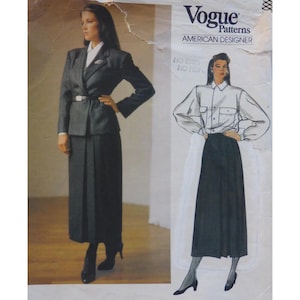 May include: Vogue Patterns American Designer sewing pattern. The pattern shows a woman in a dark grey suit with a belted jacket and long skirt. Also shown is a woman in a white shirt and long black skirt.