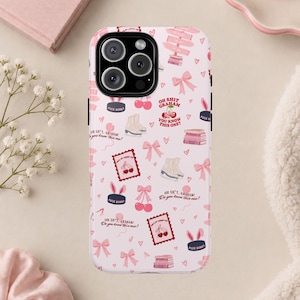 May include: A light pink phone case featuring a repeating pattern of white ice skates, pink bows, stacks of books, cherries, and hockey pucks with bunny ears. The text reads, "OH SHIT, GRAHAM! YOU KNOW THIS ONE?" and "PUCK BUNNY" in small print.