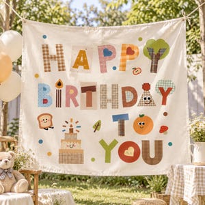 May include: A cream-colored fabric banner featuring the text HAPPY BIRTHDAY TO YOU in colorful, patterned letters. The design includes whimsical illustrations of a smiling cake, a slice of toast, an orange, trees, and a mushroom.