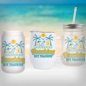 May include: Three white tumblers with a beach scene and the text "Beaching Not Teaching". The tumblers are in different sizes and styles. The background is a blurred image of a beach.