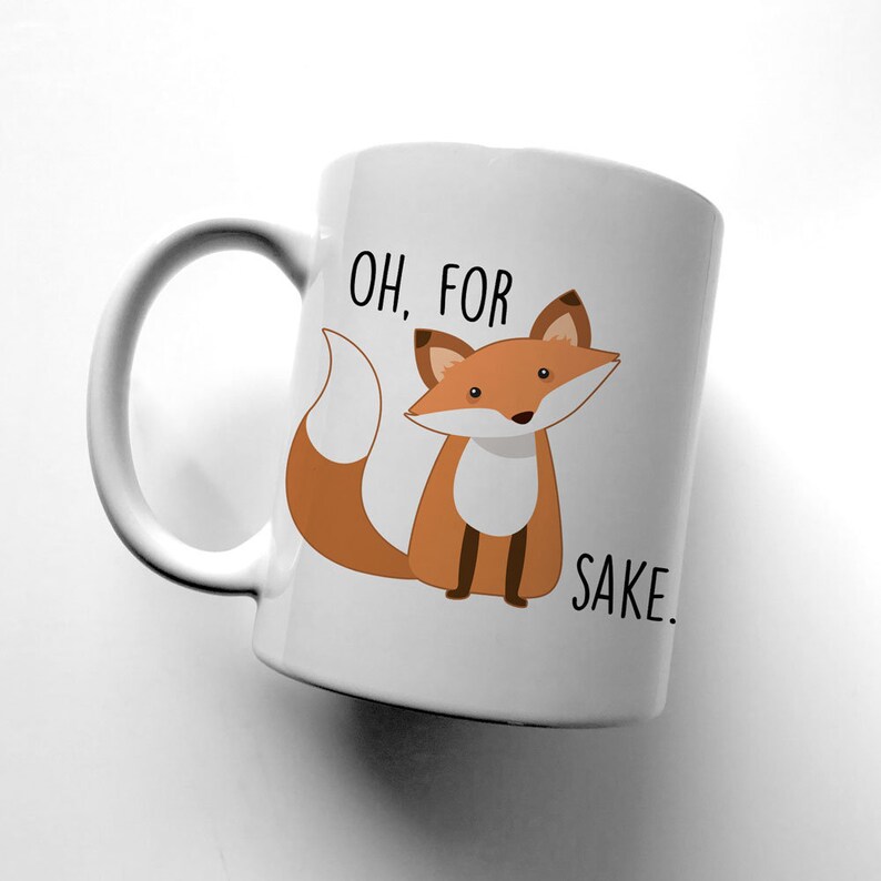 May include: White ceramic mug with a cartoon fox and the text "OH, FOR SAKE."