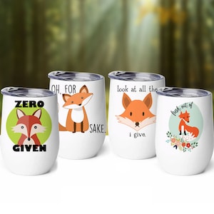 May include: Set of four white stainless steel tumblers with fox illustrations and humorous sayings. The sayings are "Zero Given", "Oh, For Sake", "Look at all the I give", and "Fresh out of".