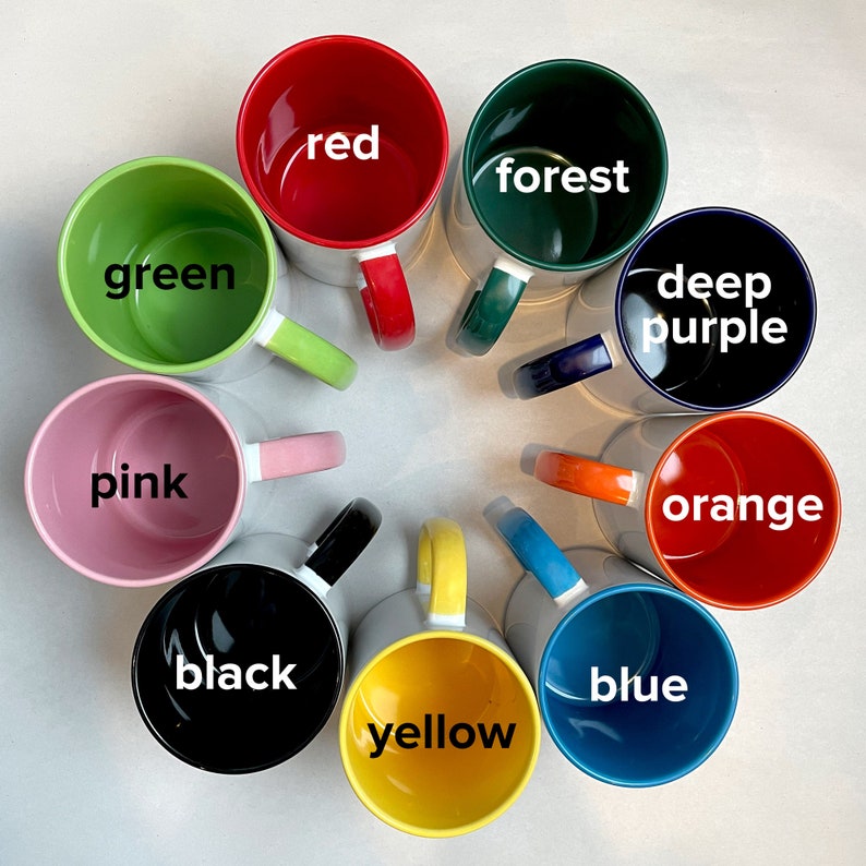 May include: Ten ceramic mugs in a circle, each with a different color and word. The colors are red, forest green, green, pink, black, yellow, blue, deep purple, orange. The words are red, forest, green, pink, black, yellow, blue, deep purple, orange.