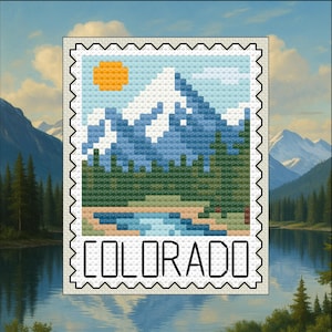 May include: A cross-stitch design of a Colorado landscape, resembling a postage stamp. The image features a mountain range with snow-capped peaks, a river, and a yellow sun. The word "COLORADO" is displayed at the bottom in capital letters.