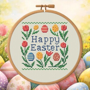 May include: A cross-stitch embroidery hoop with a "Happy Easter" design. The design features colourful tulips, Easter eggs, and the text "Happy Easter" in blue. The hoop is made of wood and is set against a spring-themed background.