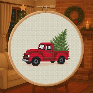 May include: Cross-stitch of a red pickup truck carrying a green Christmas tree. The embroidery is set in a wooden hoop, with a cozy holiday scene in the background, including a wreath and a lit candle.