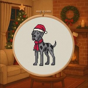 May include: A cross-stitch embroidery hoop showing a grey dog with black spots, wearing a red Santa hat and scarf. The dog is on cream fabric, set against a Christmas-themed background with a fireplace and Christmas tree.