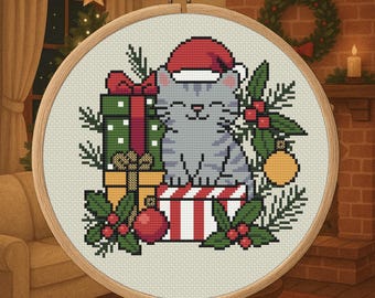 May include: Cross-stitch embroidery in a wooden hoop features a gray cat wearing a Santa hat, surrounded by Christmas gifts, holly, and ornaments. The design is set against a cozy, festive background with a fireplace and Christmas tree.