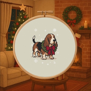 May include: A cross-stitch embroidery of a Basset Hound wearing a Christmas wreath and a red bow. The dog is brown, black, and white, with snowflakes around it. The embroidery is in a wooden hoop, with a cozy Christmas scene in the background.