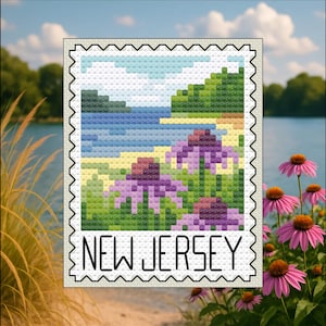 May include: A cross-stitch design of a New Jersey landscape, resembling a postage stamp. The image features a beach scene with purple flowers in the foreground and the text "NEW JERSEY" at the bottom. The background includes a lake and sky.