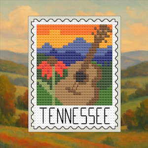 May include: A cross-stitch design of a Tennessee landscape, featuring a guitar, mountains, and flowers under a sunset. The word "TENNESSEE" is stitched at the bottom, framed by a postage stamp border.