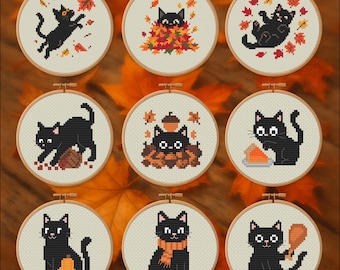 May include: Nine cross-stitch embroidery hoops featuring black cats in various autumn scenes. The cats are surrounded by fall leaves, pumpkins, and acorns. Each design is framed in a wooden hoop, creating a cozy, seasonal theme.