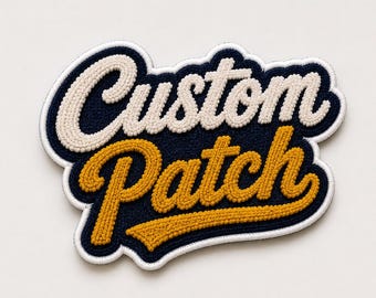 May include: A navy blue embroidered patch featuring the text Custom Patch in a cursive font. The word Custom is stitched in cream thread, while the word Patch is stitched in mustard yellow thread. The entire patch has a white border outline.