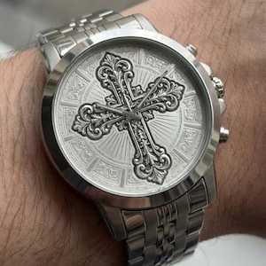 Customized gold watch featuring an ornate engraved cross on the face, personalized jewelry for men