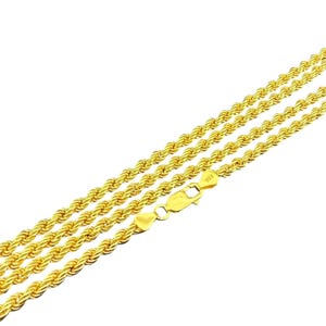 May include: Gold-colored rope chain necklace with a lobster clasp. The necklace is made of multiple strands of twisted metal, creating a rope-like texture. The clasp is marked with "925".