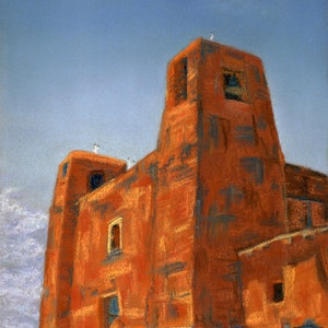 May include: A red brick building with a tall tower and a smaller tower on the left side. The building has a few windows and a door. The building is set against a blue sky.