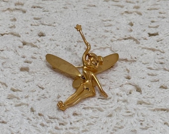 Broche vintage de Campanilla de Disney en tono dorado, raro, con alas móviles y resorte que sostienen una estrella.