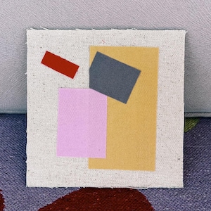 May include: Abstract artwork on a square canvas. It features a red rectangle, a grey rectangle, a pink square, and a yellow rectangle, all arranged on a textured, off-white background. The piece is likely a mixed-media collage.