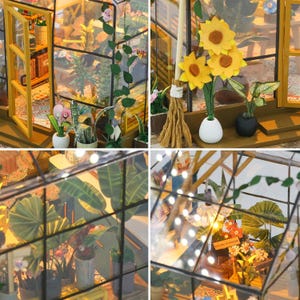 May include: A miniature greenhouse model with glass walls and a wooden frame. The interior is filled with tiny potted plants, flowers, and decorative items. The scene includes a small broom, sunflowers, and string lights, creating a charming, detailed display.