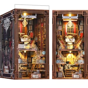 May include: Two wooden miniature bookshelf models with interior lighting. The models feature detailed bookshelves, staircases, and decorative elements. One model has the text "Beyond Library" on the side. The models are brown with warm interior lighting.