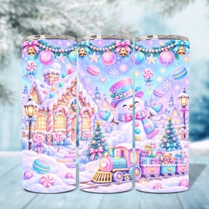 May include: A cylindrical tumbler featuring a pastel-colored winter scene with a gingerbread house, a snowman wearing a top hat, a toy train carrying gifts, Christmas trees, candy canes, macarons, and hanging ornaments against a snowy backdrop.