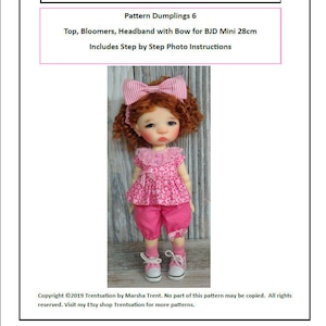 May include: A pink and white doll outfit for a 28 cm BJD doll. The outfit includes a pink top with white polka dots, pink bloomers with white polka dots, and a pink headband with a white bow. The doll is wearing white sneakers. The image includes the text "Trentsation by Marsha Trent" and "Pattern Dumplings 6".