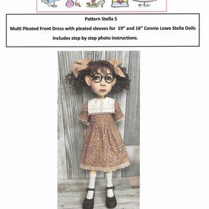 May include: A doll wearing a brown patterned dress with pleated sleeves, white collar, and black shoes. The doll has curly brown hair, glasses, and bows. The image includes text: "Trentsation by Marsha Trent" and "Pattern Stella 5".