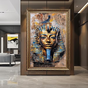 May include: A framed painting depicting a bust of an Egyptian pharaoh. The pharaoh's face is gold with blue and gold headdress and collar. The background features hieroglyphs and a textured, aged appearance. The frame is gold.