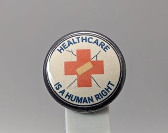Healthcare Is a Human Right – 1" Button (Design 1.3) – People Over Profit Series