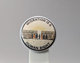 Migration is a Human Right – 1" Button (Design 2) – People Over Borders Series