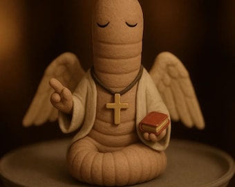 May include: A whimsical figurine of a worm-like creature with closed eyes, wearing a white robe, a cross necklace, and angel wings. It holds a small red book and is seated on a gray plate. The figure has a light brown color.