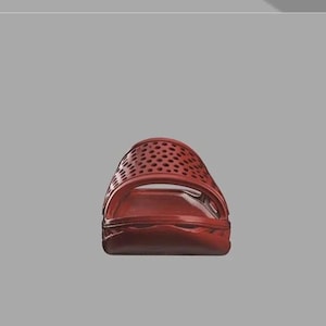 May include: A red slide sandal with a perforated upper. The sandal has a contoured footbed and a thick sole. The design features small holes across the top of the sandal.