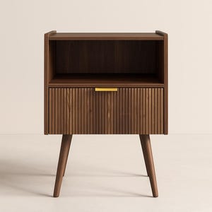 May include: A mid-century modern style nightstand in dark brown wood. The nightstand has a drawer with vertical ribbed detailing and a gold-colored handle. It features a shelf and is supported by angled legs.