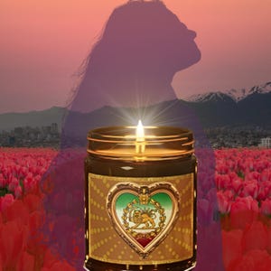 May include: A lit candle in a brown glass jar with a gold rim and a heart-shaped label featuring a lion emblem. The background shows a field of red tulips, mountains, and a silhouette of a person.
