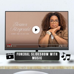 May include: A flat-screen monitor displays a funeral slideshow with music. The screen shows a woman with glasses and a brown jacket. Text on the screen reads "Eleanor Fitzgerald" and dates. A black bar at the bottom says "FUNERAL SLIDESHOW WITH MUSIC".