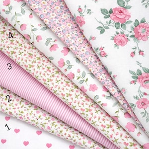 May include: Seven folded fabric swatches from the Pink Ballet Collection, numbered 1 through 7. Patterns include pink hearts on white, small floral prints, pink and white stripes, and large pink roses with green leaves on a white background.