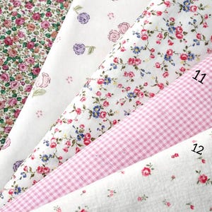 May include: Five folded fabric swatches from the Spring Bloom Collection labeled 8 through 12. Patterns include dense pink roses, scattered purple and pink rosebuds, small red and blue floral prints, a pink gingham check, and tiny red rosebuds.