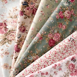May include: Six folded fabric swatches labeled 13 through 18, featuring floral patterns with pink roses and green foliage on various backgrounds including light blue, beige, sage green, and white. The text reads Vintage Rose Garden Collection.