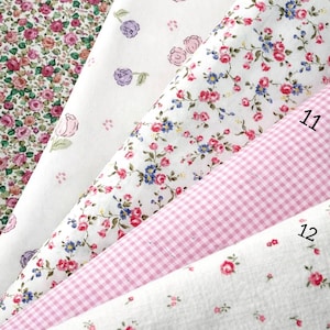May include: Five fabric swatches from the Spring Bloom Collection labeled 8 through 12. Patterns include dense pink roses, scattered pink and purple rosebuds on white, small red and blue floral sprigs, a pink gingham check, and tiny red roses.