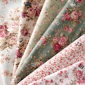 May include: Six fabric swatches from the Vintage Rose Garden Collection labeled 13 through 18. The patterns feature various floral designs with pink roses and green leaves on backgrounds of light blue, beige, sage green, dark green, and white.