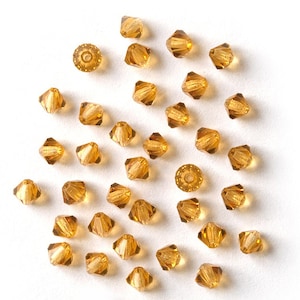 M.C. Beads Bicones 4 mm Amber 30 pcs.