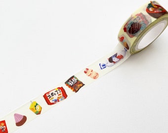 May include: Decorative washi tape featuring colorful illustrations of Japanese snacks and food items. The tape roll displays images of ramen, candy, and packaged snacks. The tape is on a white background.